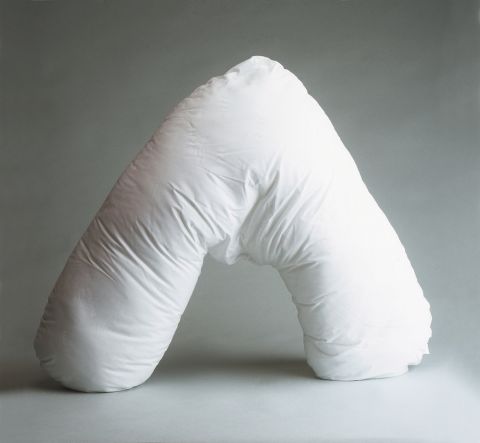 Woman using a V-Shaped Back Support Pillow